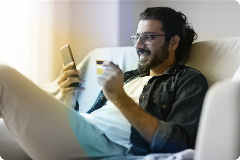 Person holding mobile and credit card