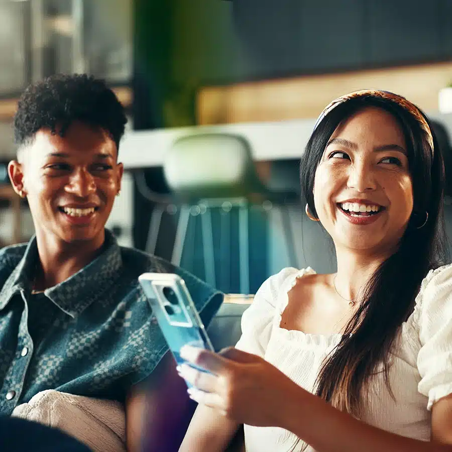 Wom and and man with mobile phone smiling